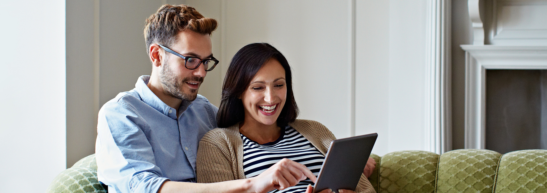 Couple smiling at tablet